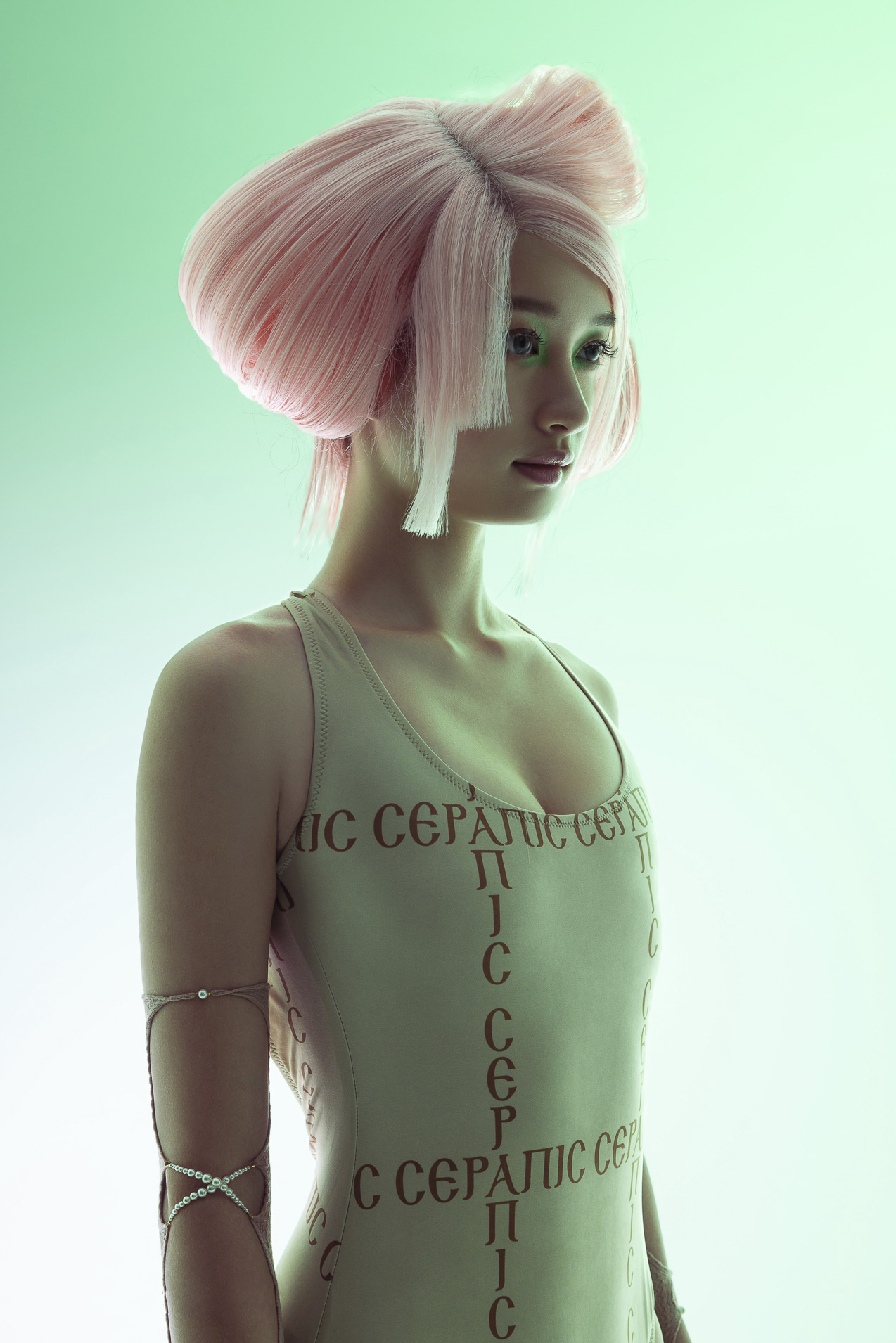 A woman standing with pink hair